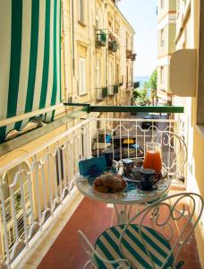 a table with a plate of food on a balcony at Marilisa Holidays in Maiori