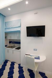 a kitchen with a white table and a sink at Marilisa Holidays in Maiori