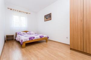 Postel nebo postele na pokoji v ubytování Apartman Justinić