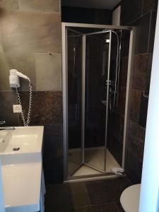 a shower with a glass door in a bathroom at Casa Alva in Trin