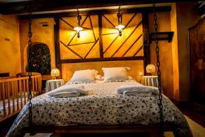 a bedroom with a large bed with a wooden headboard at La Mora Cantana in Castrojeriz