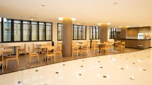 a dining area with tables and chairs in a building at VISA Hotel Hua Hin - SHA Plus in Hua Hin