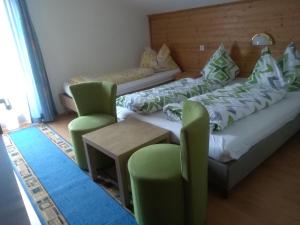 ein Wohnzimmer mit 2 Betten und 2 Stühlen in der Unterkunft Ferienhaus Reschreiter in Abtenau