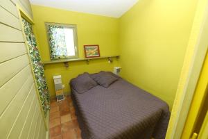 a small bedroom with a bed in the corner at Gîtes La Pousterle De Sabran in Sabran