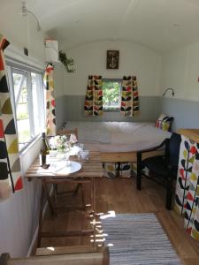 a room with a table and a bed in it at The Hut at Downlands in Warminster