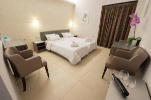 Postel nebo postele na pokoji v ubytování Astron Hotel