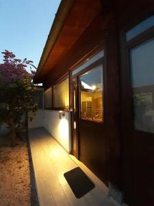 a door to a house with a porch and a window at Una piccola casa al mare in San Domino