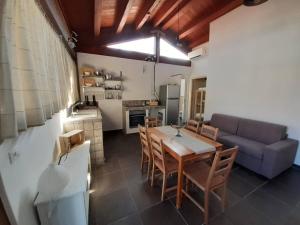 a living room with a table and a couch at Una piccola casa al mare in San Domino