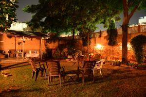 a group of chairs and a table in a yard at Jaswant Niwas in Jodhpur