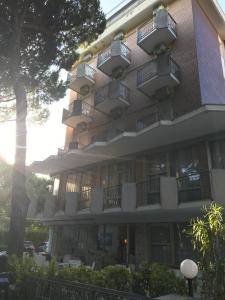a building with balconies on the side of it at Hotel Haiti in Milano Marittima