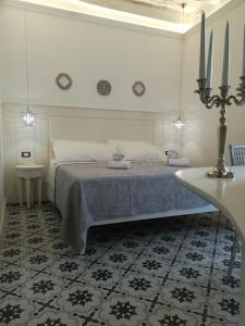 a white bedroom with a bed and a table at BellaVita accomodation in Tropea