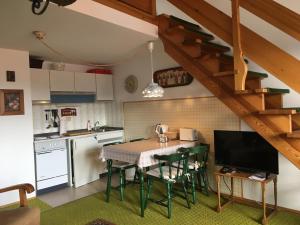 a kitchen with a table and chairs in a kitchen at Ferienwohnung Ewa in Grassau