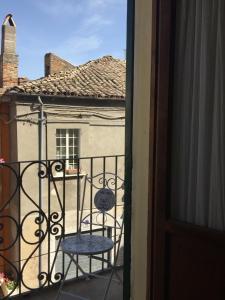 La stanza di Caterina في Villalfonsina: كرسي جلوس على شرفة مع مبنى