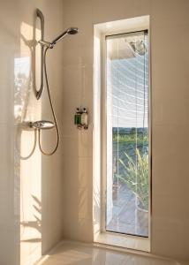 a bathroom with a shower with a glass door at Meadow Cottage Bed & Breakfast in Hawkhurst