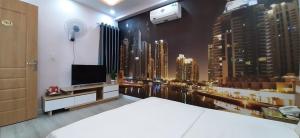 a bedroom with a large window of a city at SƠN HÀ Motel in Hai Phong