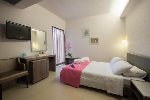 Postel nebo postele na pokoji v ubytování Astron Hotel