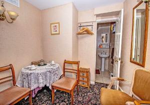 a room with a table and chairs and a sink at Number One Guesthouse in Dover