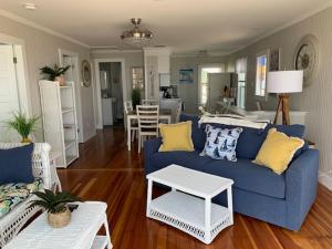 a living room with a blue couch and a kitchen at The York in Old Orchard Beach