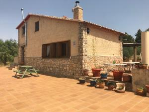 una casa con macetas delante de ella en Mas Arboretum en La Pobla de Cérvoles