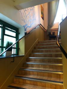 a set of stairs in a building with a painting on the wall at The Queens Hostel in London