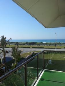 a balcony with a view of the ocean at Palm Beach Guesthouse in Port Elizabeth