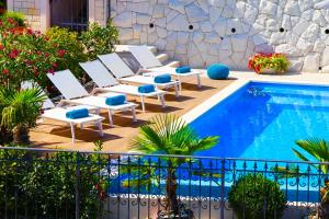 a group of chairs and a swimming pool at Villa Sea Breeze in Split
