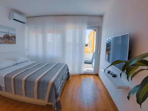 a bedroom with a bed and a sliding glass door at City Center Studio 4 Two in Pula