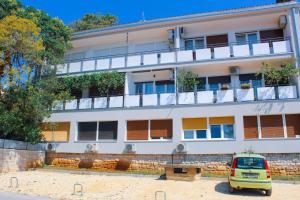 a yellow car parked in front of a building at City Center Studio 4 Two in Pula