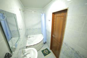 a small bathroom with a toilet and a sink at Rasulboy Guest House in Khiva +30 photos