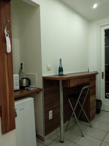 a kitchen with a table with a bottle on it at Gyöngyi apartman in Budapest