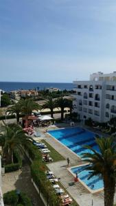 a view of a swimming pool with chairs and palm trees at Algarve/Sra da Rocha in Porches
