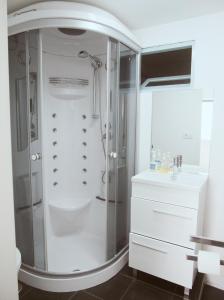 a white bathroom with a shower and a sink at Cangosta House in Fão