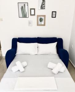 a blue bed with white pillows on top of it at Minimal Apartment Center Kavala in Kavála