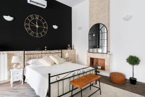 a bedroom with a large bed and a clock on the wall at Royal Piazza di Spagna in Rome