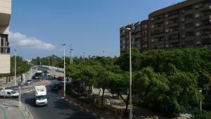 a view of a street with cars and buses at Hostal María in Elche
