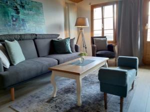 a living room with a couch and a coffee table at App. Seeblick Top of Interlaken in Beatenberg