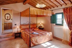 a bedroom with a large bed and a large window at Podere La Ciabatta in Casole dʼElsa