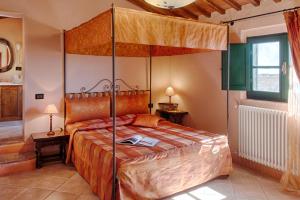 a bedroom with a bed and a canopy at Podere La Ciabatta in Casole dʼElsa