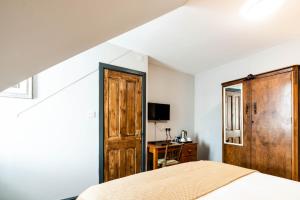 a bedroom with a bed and a wooden door at Cappadocia Guest House in Brighton & Hove