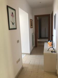 a hallway with a room with a table and a picture on the wall at Central House Terracina in Terracina