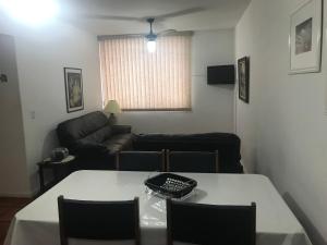 a living room with a table and a couch at Apartamento Praia do Forte - Cabo Frio in Cabo Frio