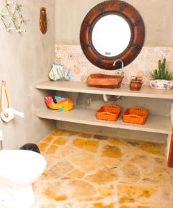 a bathroom with a toilet and a mirror on the wall at Flats Macapá Meu Amor in Luis Correia