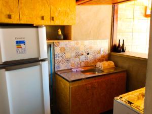 a kitchen with a refrigerator and a sink at Flats Macapá Meu Amor in Luis Correia