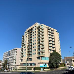 a large apartment building on a city street at Nesuto Parramatta in Sydney