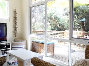a living room with a table and a large window at Blairgowrie Beach Escape in Blairgowrie