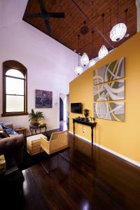 a living room with yellow walls and a couch at Angel Place Robertson in Robertson