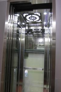 a metal elevator in a room with a ceiling at QUANG SAIGON Hotel- 40-7 Bùi Viện-Walking street in Ho Chi Minh City
