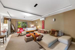 a living room filled with furniture and a couch at Noosa Hinterland Retreat in Tinbeerwah