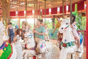 a group of people riding on a carousel at Pullman Nanchang Sunac in Nanchang