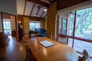 a dining room with a wooden table and chairs at Denmark Forest Retreat in Denmark